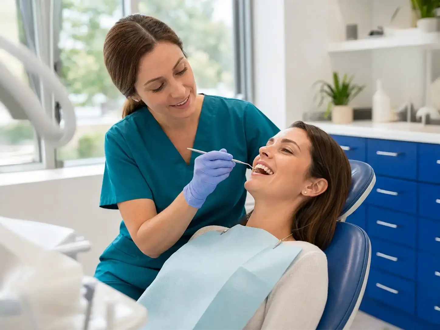 hygienist cleaning a patients teeth