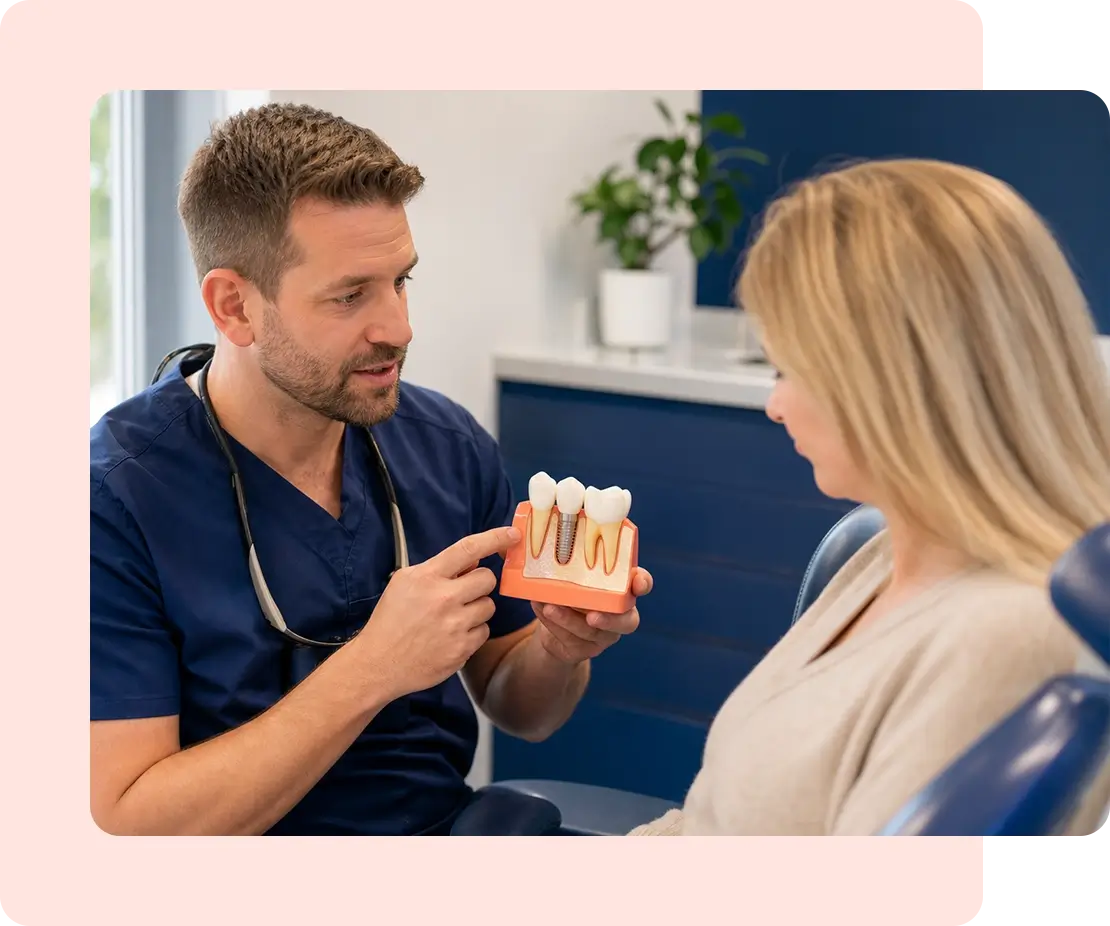 dentist reviewing an implant model with a patient.